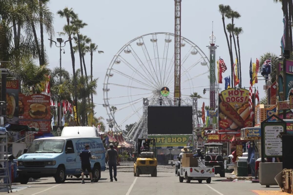 Workers prepare for the opening of the San Diego County Fair in 2019.