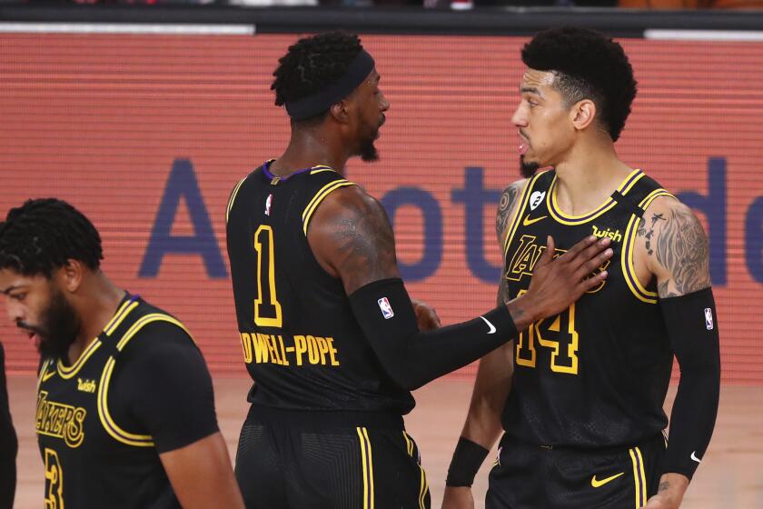 Lakers guards Danny Green, right, and Kentavious Caldwell-Pope talk during Game 4 against Portland on Aug. 24, 2020.