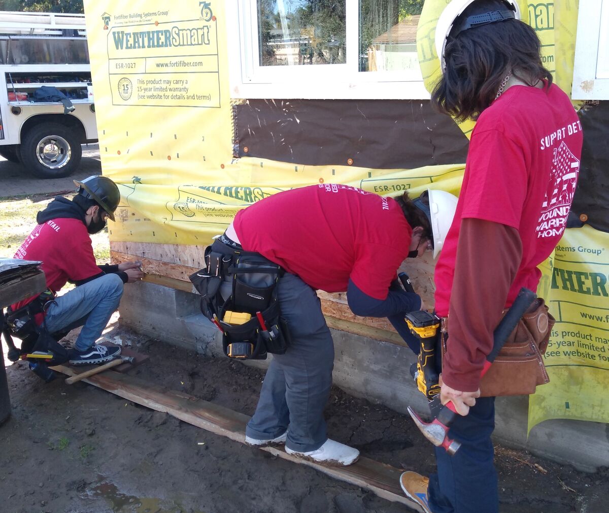 Montecito High students add earthquake straps to the Wounded Warrior Homes cottage.