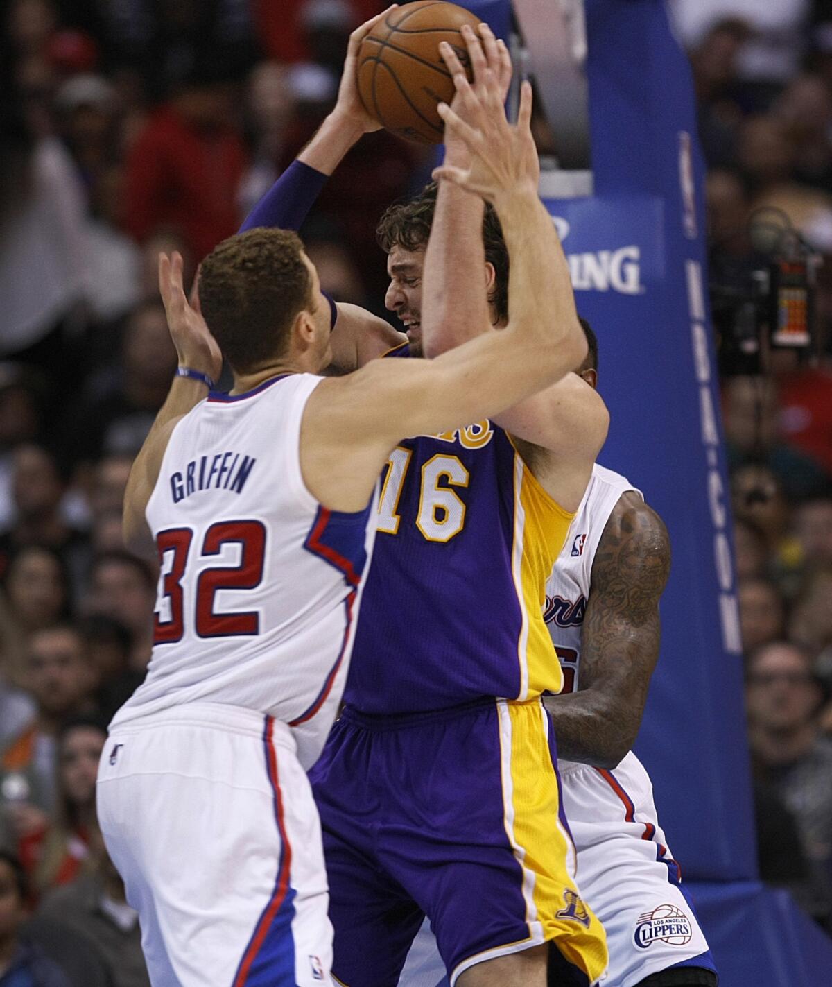 Lakers power forward Pau Gasol is trapped between Clippers power forward Blake Griffin (32) and center DeAndre Jordan (6) in the first half.