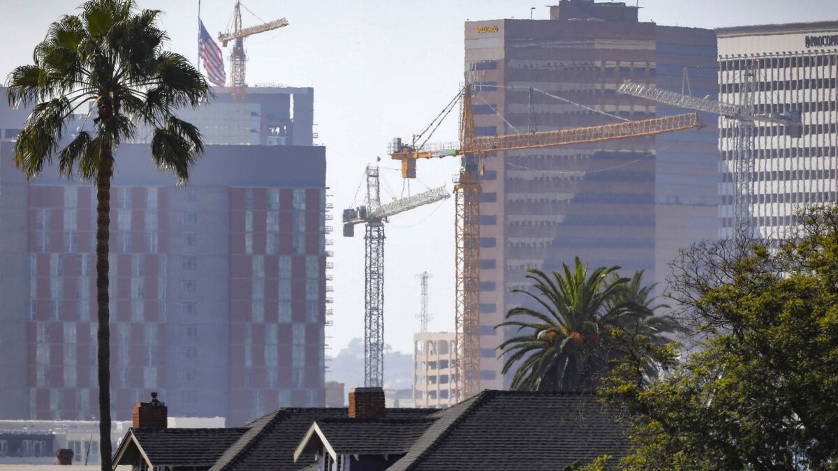 Construction cranes in downtown San Diego reflect the development going on.