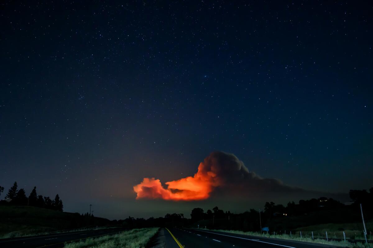 A starry night view of the smoke clouds rising from the Ranch fire burning in the Mendocino National Forest, as seen from in Lakeport, Calif., on Aug. 1, 2018. (Marcus Yam / Los Angeles Times)