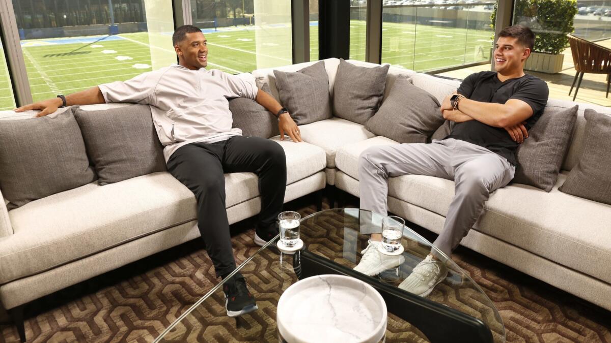 Seattle Seahawks quarterback Russell Wilson, left, talks with former Oklahoma State QB Mason Rudolph on the UCLA set of Wilson's new ESPN show last month.