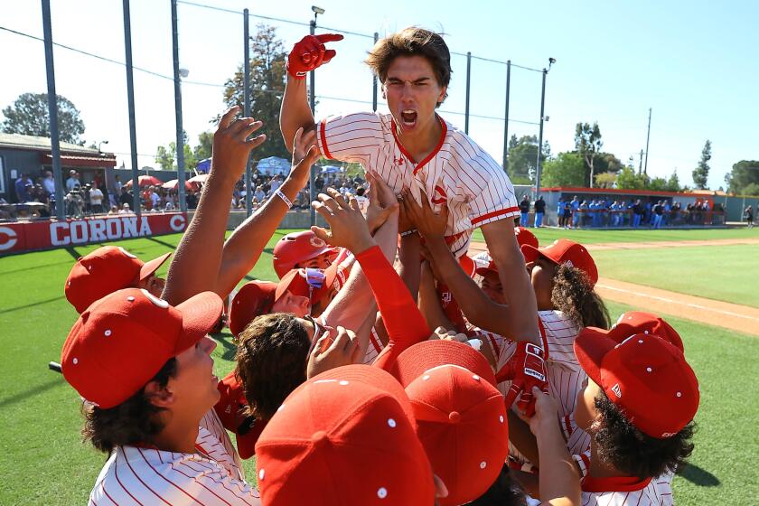 Seth Hernandez of Corona celebrates after hitting the first of his two three-run home runs.