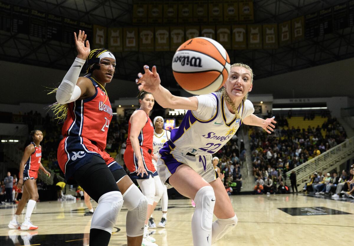 Sparks forward Cameron Brink lunges for a loose ball against Mystics forward Aaliyah Edwards in the first half.