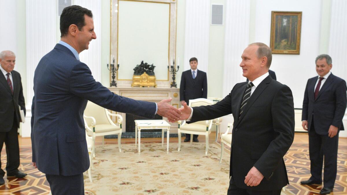 Russian President Vladimir Putin, right, greets Syrian President Bashar Assad at the Kremlin on Oct. 20, 2015.