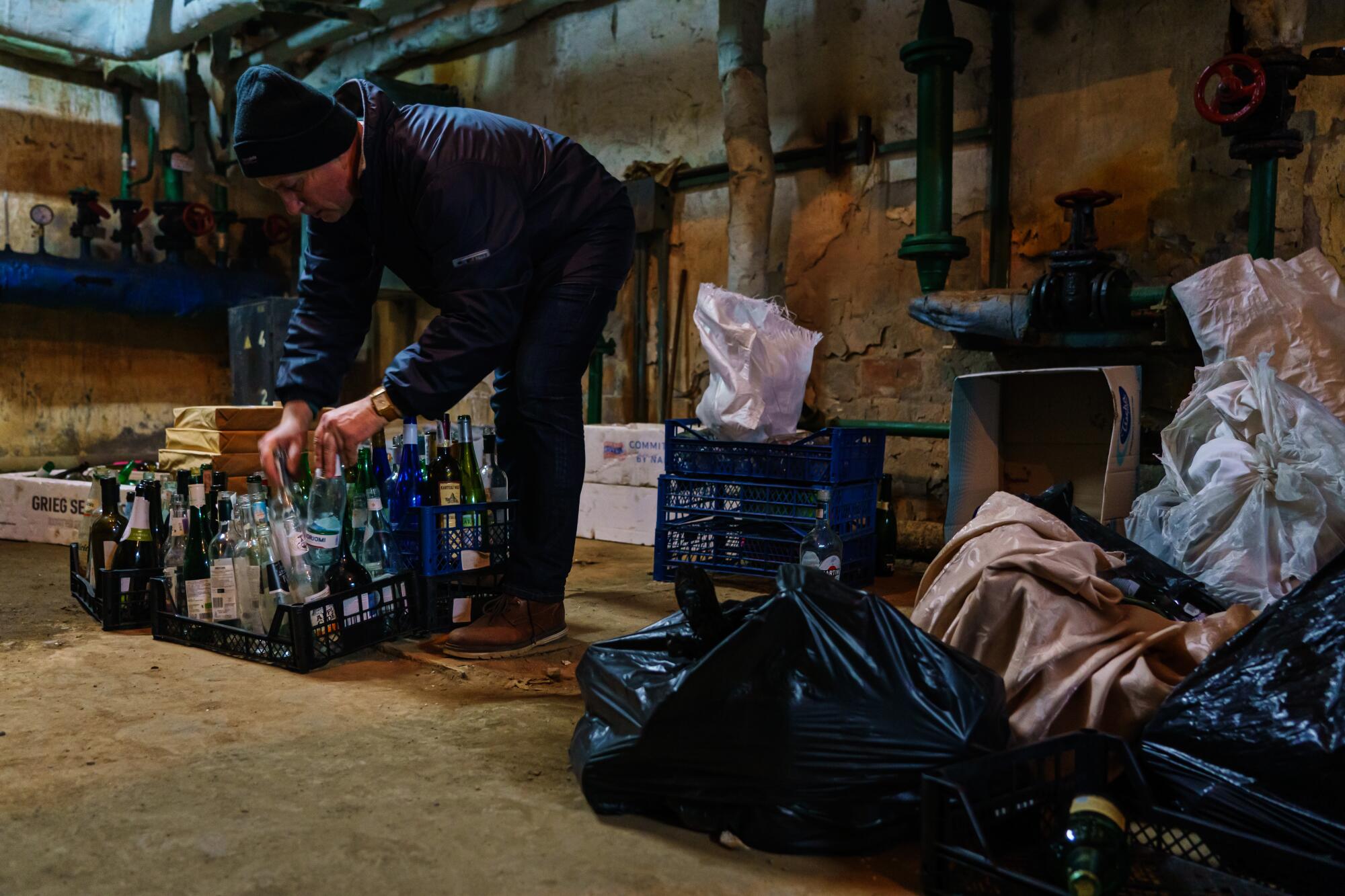 Volunteers from the Territorial Defense Units collect glass bottles to make Molotov cocktails