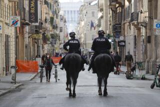 Mounted police officers patrol Via del Corso main shopping street, in downtown Rome, Saturday, April 3, 2021. Italy went into lockdown on Easter weekend in its effort to battle then Covid-19 pandemic. (AP Photo/Gregorio Borgia)
