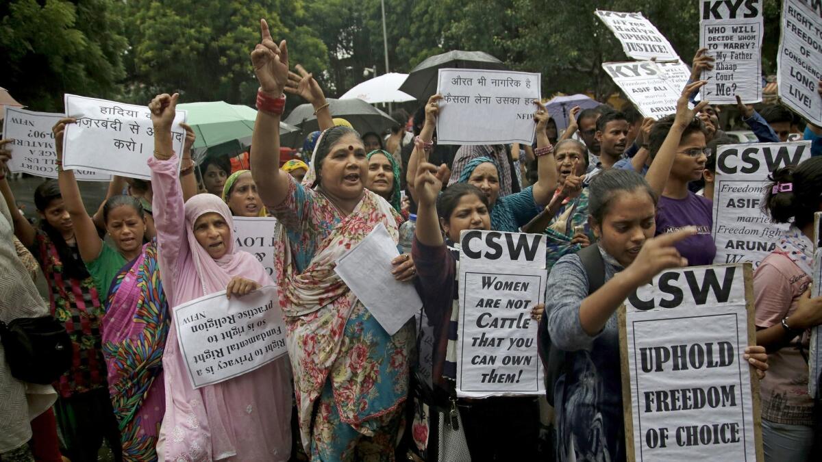 Rights activists protest a 2017 judgement by an Indian court which nullified a woman's marriage with a Muslim man after the bride's father alleged his daughter was converted to Islam at the behest of Islamic State.