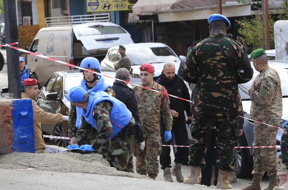 U.N. peacekeepers and Lebanese soldiers investigating attack scene