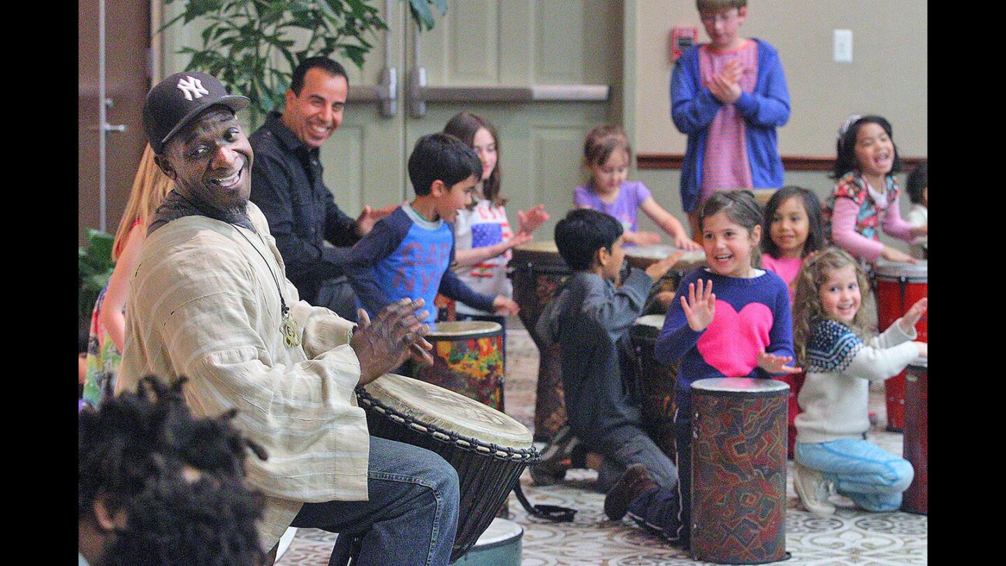 Drummer Marcus Miller, with his newly found rhymic children, pound out a beat at family night at the Buena Vista Branch Library Burbank on Thursday, March 31, 2016. Miller brought over 35 drums for just about that many children in attendance to play and make rhythms with.