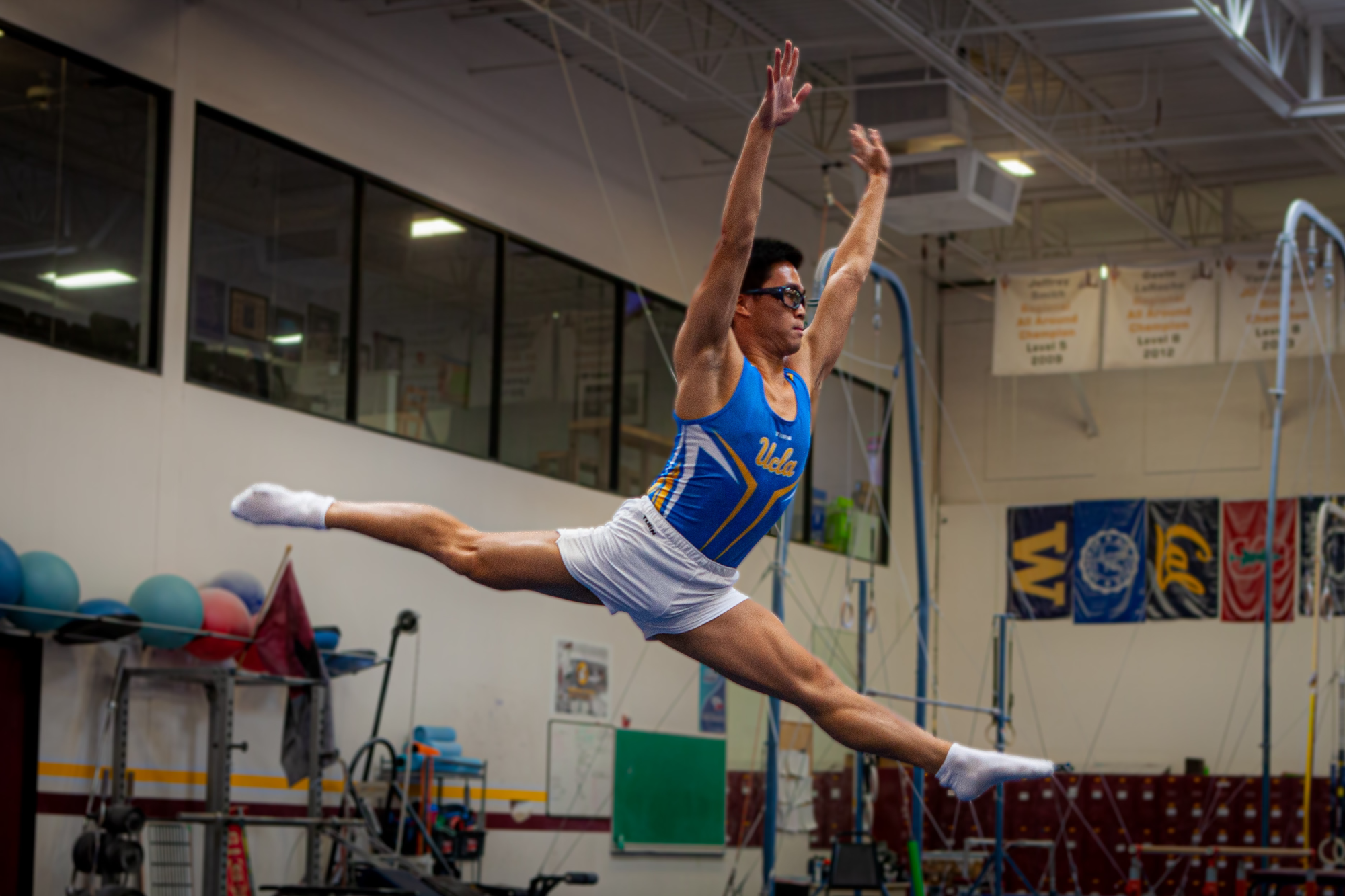UCLA gymnastics enthusiast Josh Lim performs an exercise routine on the club floor.