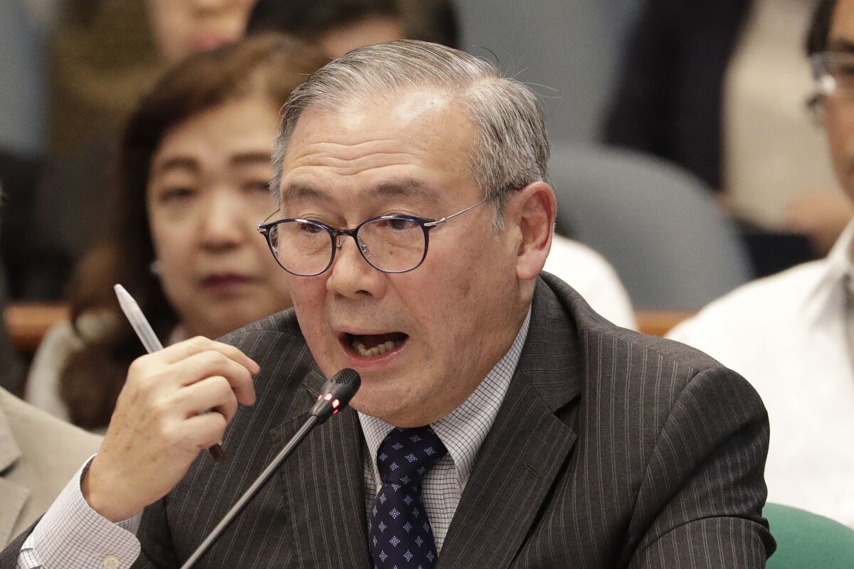 FILE - In this Feb. 6, 2020, file photo, Philippine Secretary of Foreign Affairs Teodoro Locsin Jr. gestures during a senate hearing in Manila, Philippines. Locsin apologized Tuesday, May 4,2021, after tweeting an obscene phrase demanding China get out of Philippine-claimed territory in the South China Sea in an outburst that annoyed the Philippine president. (AP Photo/Aaron Favila, File)
