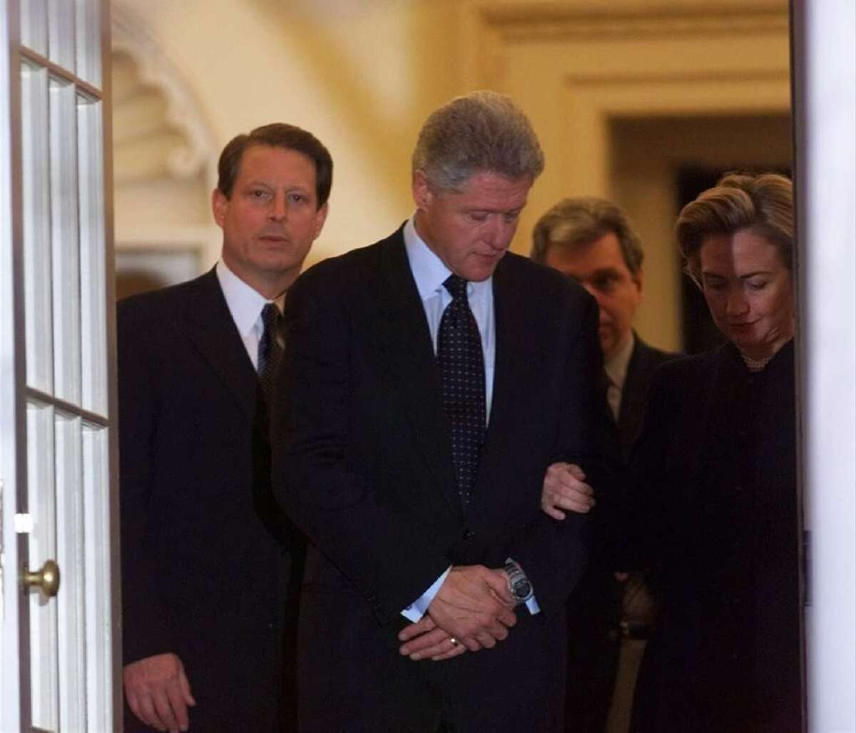 President Bill Clinton at the White House in December 1998, flanked by Vice President Al Gore and First Lady Hillary Rodham Clinton, after the House vote to impeach him.