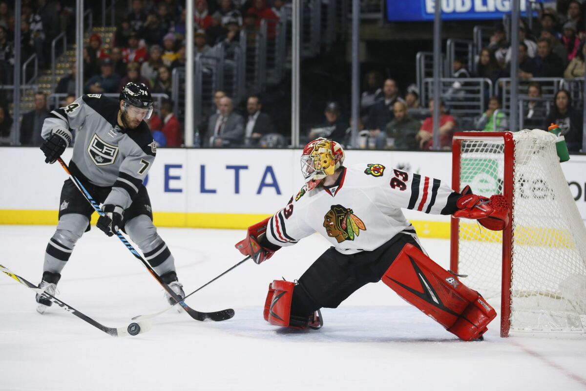 Blackhawks goalie Scott Darling prevents Kings left wing Dwight King from scoring during the second period.