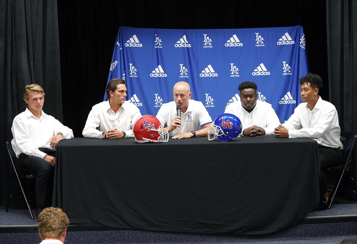 Los Alamitos' John Newman, Cade McConnell, coach Ray Fenton, Zatyvion Miller, and Giovanni De Leon participate during media day at Mission Viejo High on Wednesday.