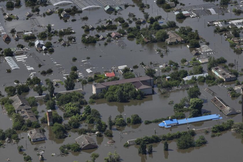 CAPTION CORRECTS LOCATION - Houses are seen underwater in the flooded village of Dnipryany, in Russian-occupied Ukraine, Wednesday, June 7, 2023, after the collapse of Kakhovka Dam. (AP Photo)