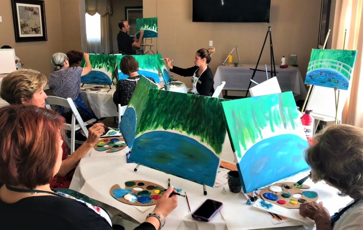 Participants in Living Information for Today (LIFT), a campaign started by Dignity Memorial, enjoy a painting class together.