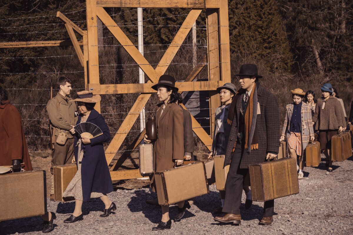 Japanese Americans carrying their belongings into an internment camp in "The Terror: Infamy"