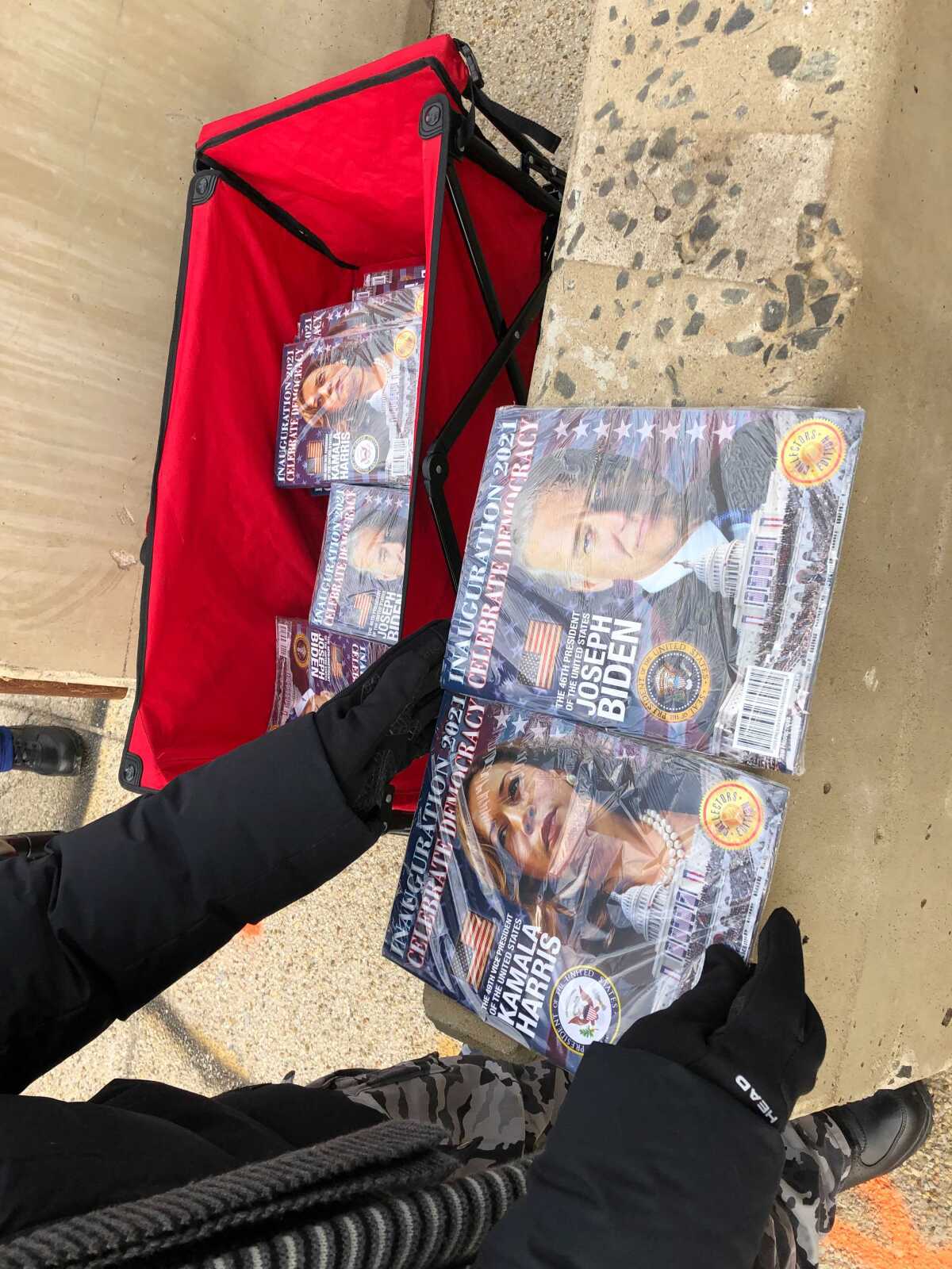 A vendor near Union Station in Washington showcases inauguration booklets for sale.