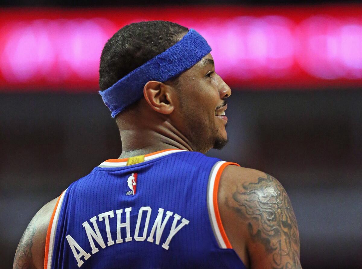 The New York Knicks' Carmelo Anthony smiles at fans who call his name during a game against the Chicago Bulls on March 23.