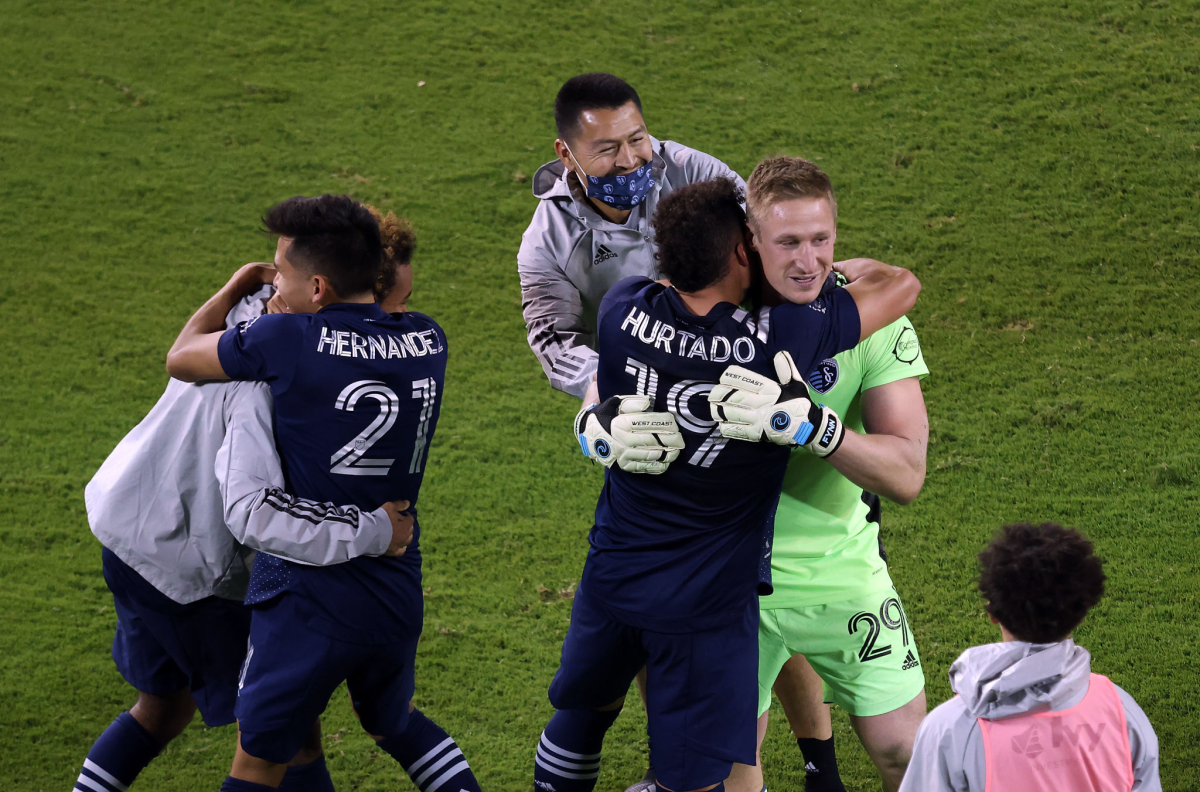 Sporting Kansas City players rush to congratulate goalkeeper Tim Melia.