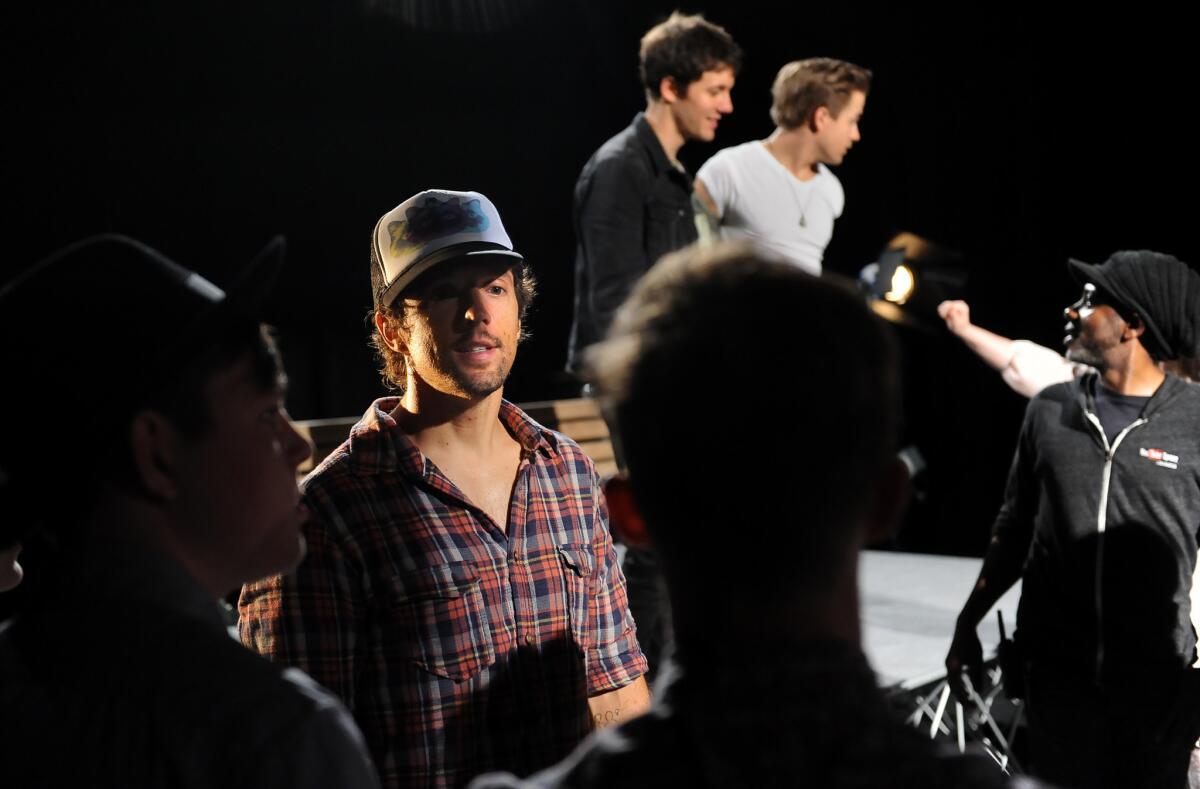 Recording artist Jason Mraz speaks with extras during a video shoot with YouTube stars in Los Angeles.