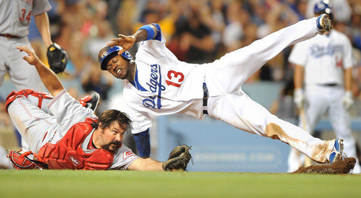 Dodgers shortstop Hanley Ramirez, right, is tagged out at home by Cincinnati Reds catcher Corky Miller during the fourth inning of the Dodgers' 2-1 win Friday.