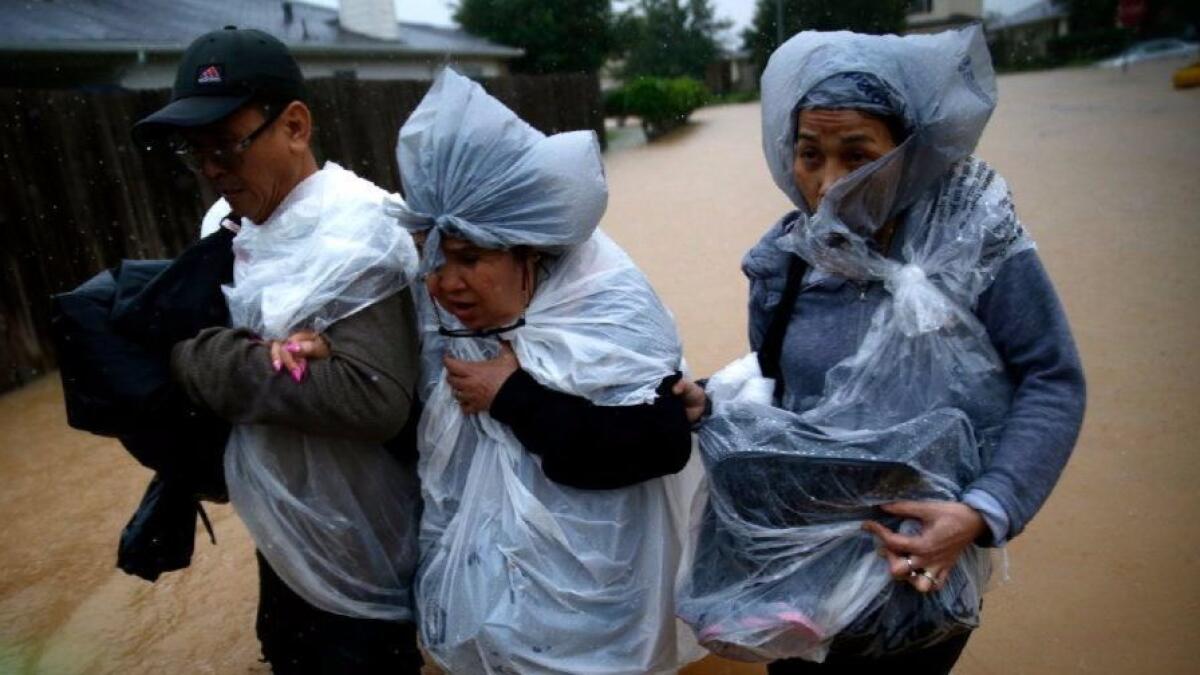 Residents head for dry ground in Clodine, Texas. News coverage on Harvey and its aftermath, and a Times column on the topic, met with readers’ approval.