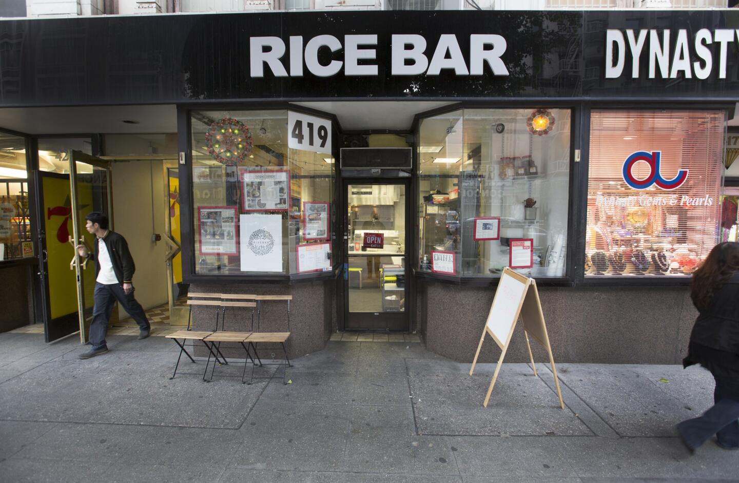 Look through the windows of Rice Bar and inside you'll see a wrap-around marble bar where customers can belly up to one of seven stools for a sit-down lunch. Customers can also pick up orders to go and get a can of soda from a cooler.