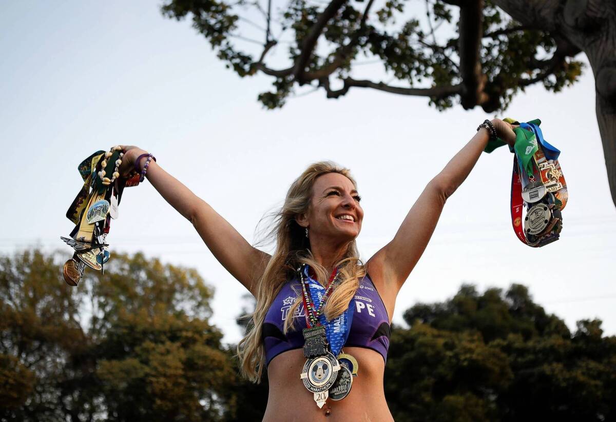 Marathon runner Julie Weiss displays her medals.