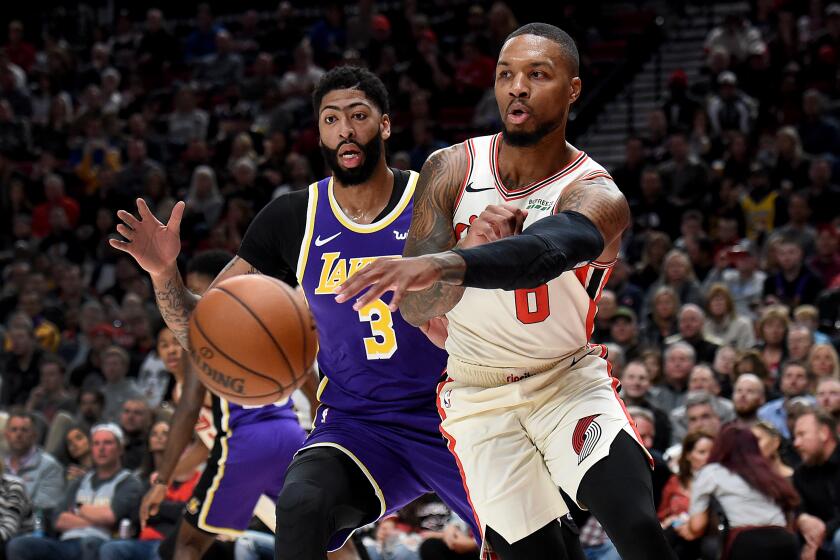 PORTLAND, OREGON - DECEMBER 06: Damian Lillard #0 of the Portland Trail Blazers passes the ball as Anthony Davis #3 of the Los Angeles Lakers defends during the first half of the game against the Los Angeles Lakers at Moda Center on December 06, 2019 in Portland, Oregon. NOTE TO USER: User expressly acknowledges and agrees that, by downloading and or using this photograph, User is consenting to the terms and conditions of the Getty Images License Agreement. (Photo by Steve Dykes/Getty Images) ** OUTS - ELSENT, FPG, CM - OUTS * NM, PH, VA if sourced by CT, LA or MoD **