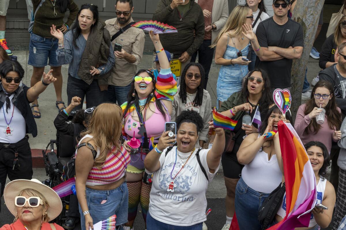 Participants make there way along Hollywood Blvd. during the Gay Pride Parade Sunday.