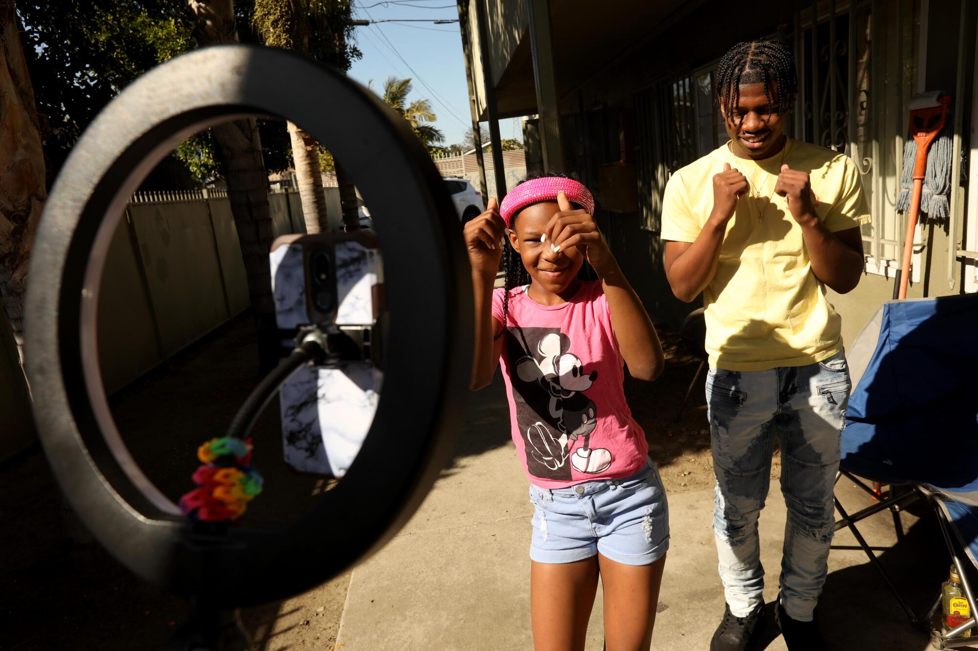 Terrell Weaver, right, makes a TikTok video with his sister Micah Beime