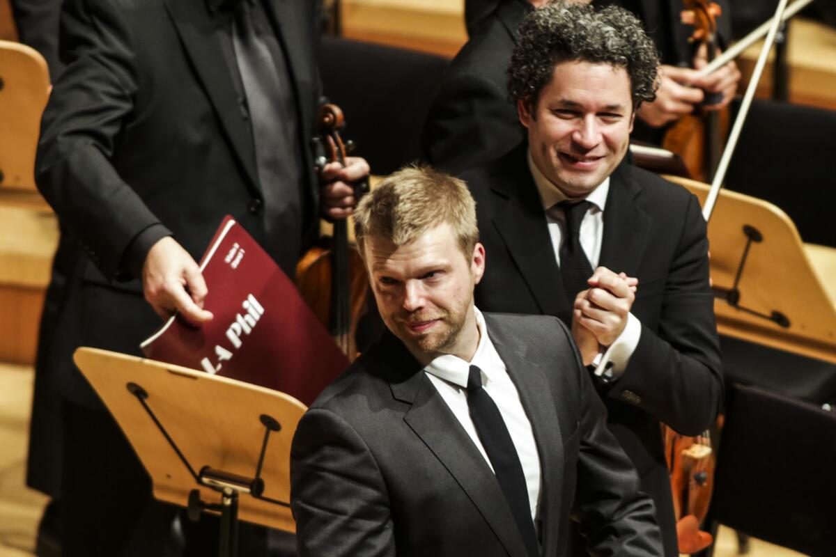 Composer Andrew Norman takes his bow at the 2018 L.A. Phil performance of "Sustain." The recording of the work received two Grammy nominations Wednesday.