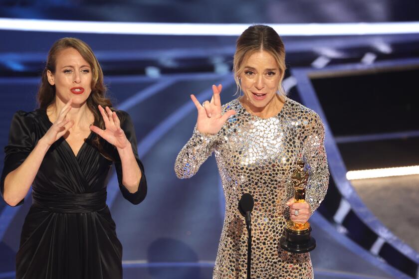 HOLLYWOOD, CA - March 27, 2022. Sian Heder accepts the Oscar for Best Adapted Screenplay for ‘CODA’ during the show at the 94th Academy Awards at the Dolby Theatre at Ovation Hollywood on Sunday, March 27, 2022. (Myung Chun / Los Angeles Times)