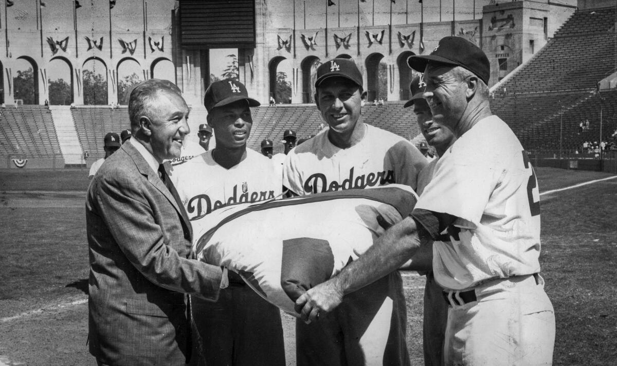 April 17, 1960: Baseball Commissioner Ford Frick, left, presents the 1959 World Championship pennant to the Los Angeles Dodgers, from left: Charlie Neal, Gil Hodges, Wally Moon and manager Walt Alston. 