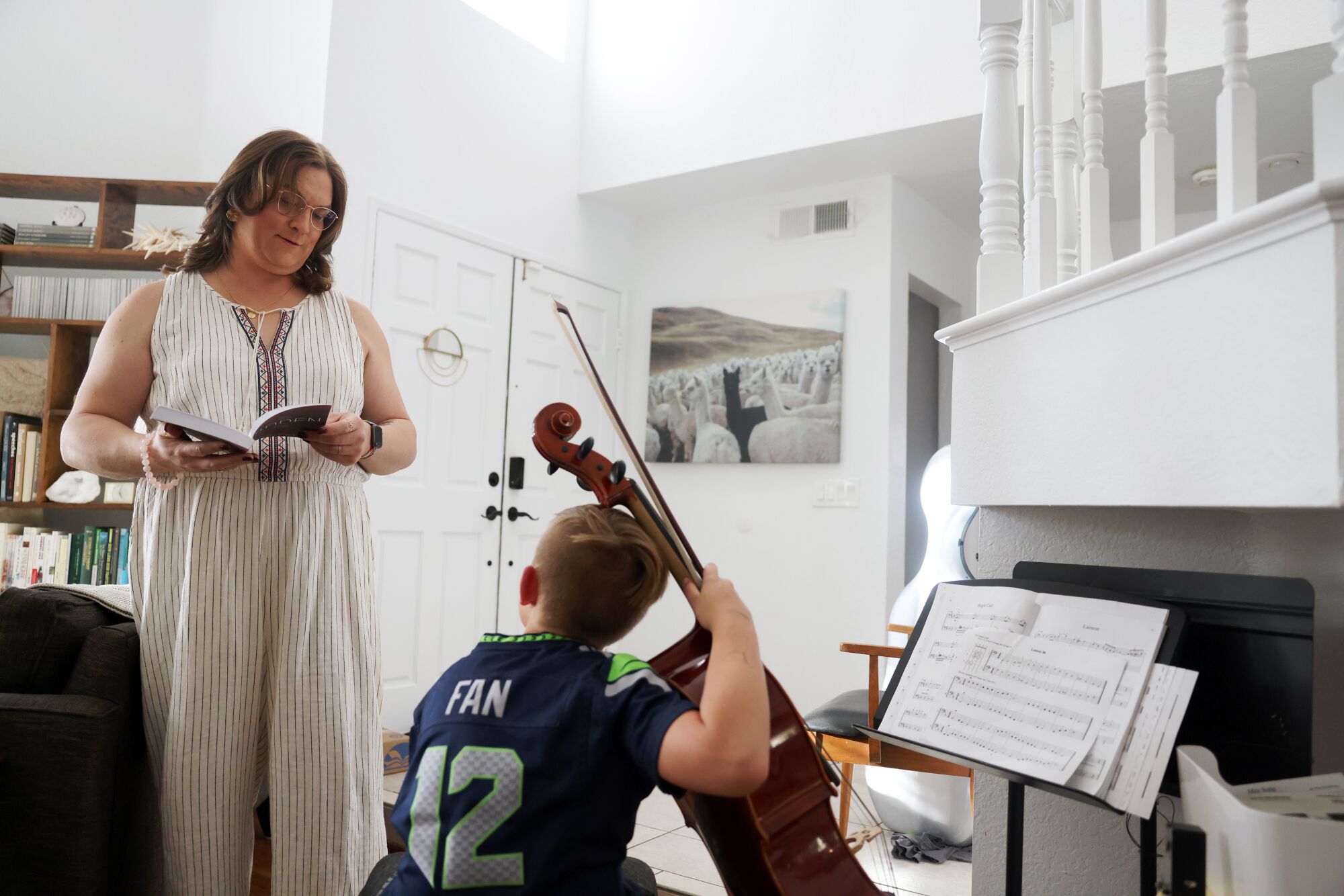 Esther Loewen stands near her son as he practices the cello