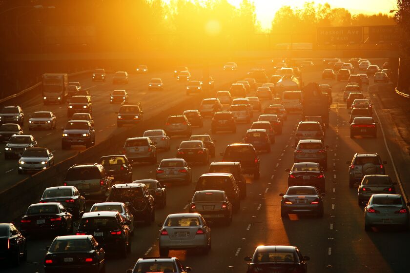 Morning traffic begins to swell on the 101 Freeway in the San Fernando Valley in March. Legislation to reduce carbon emissions in California was withdrawn at the Capitol on Thursday after opposition mounted.