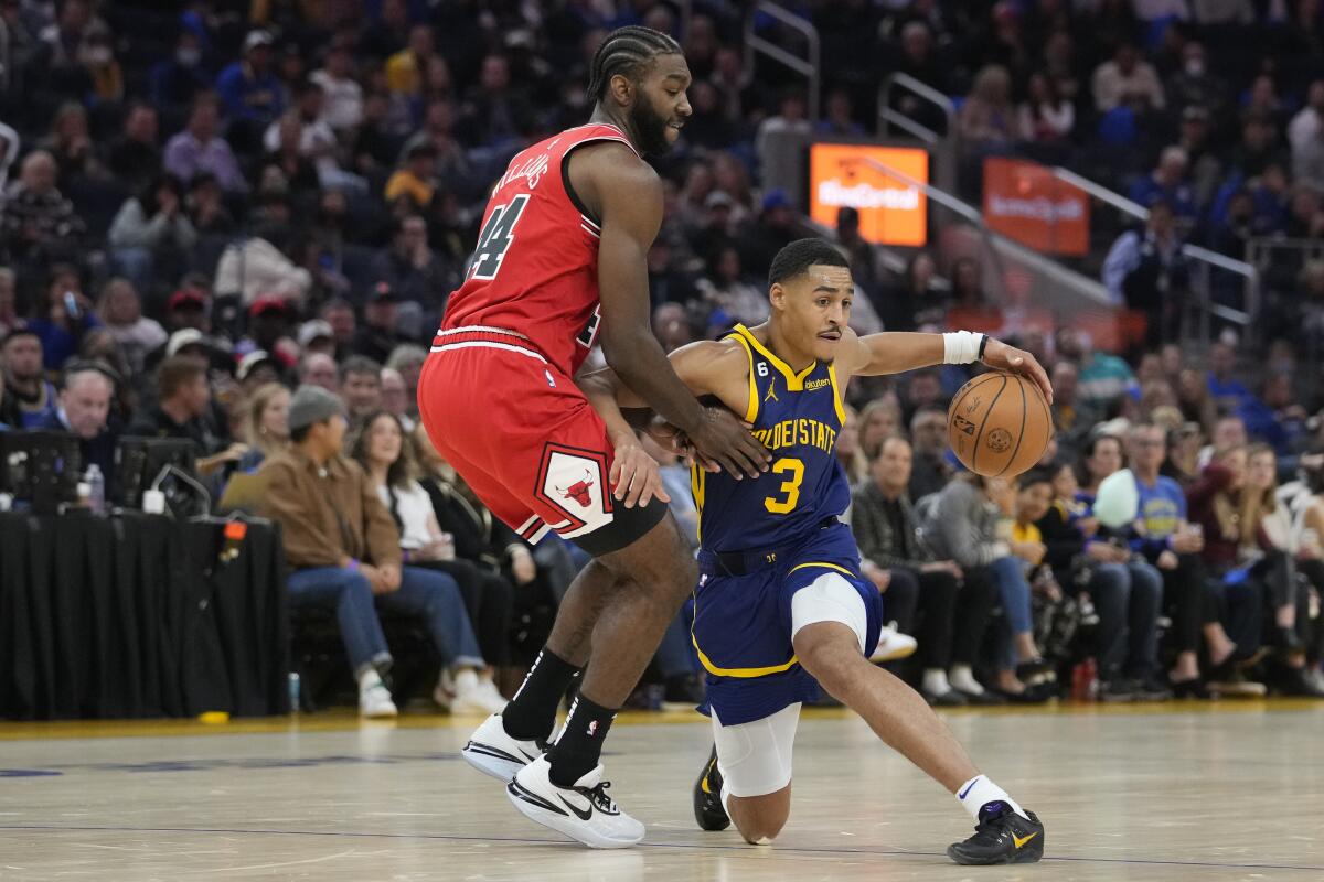 Golden State Warriors guard Jordan Poole (3) changes direction while defended by Chicago Bulls forward Patrick Williams (44) during the first half of an NBA basketball game in San Francisco, Friday, Dec. 2, 2022. (AP Photo/Godofredo A. Vásquez)