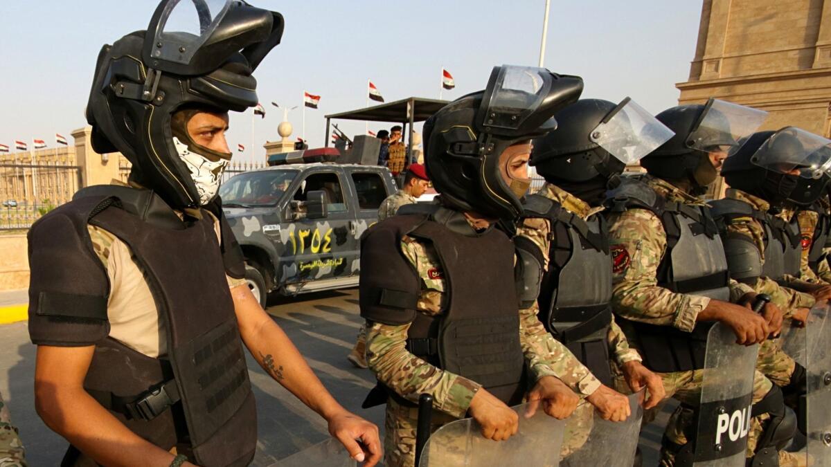 Security forces deploy around the provincial government building during a demonstration demanding better public services and jobs in Basra, 275 miles south of Baghdad, on Sept. 12, 2018.