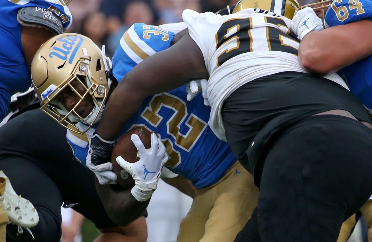 UCLA running back Christian Grubb fights his way for a seven-yard touchdown run Sept. 10, 2022.