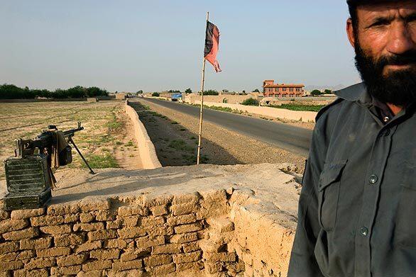 An Afghan police checkpoint on Highway 517, which leads to Bala Baluk district and the village of Garani, where provincial officials say 140 civilians were killed in U.S. airstrikes during clashes with militants on May 4. The U.S. military disputes the numbers and blames the Taliban for the majority of the deaths, saying militants lobbed grenades into homes.