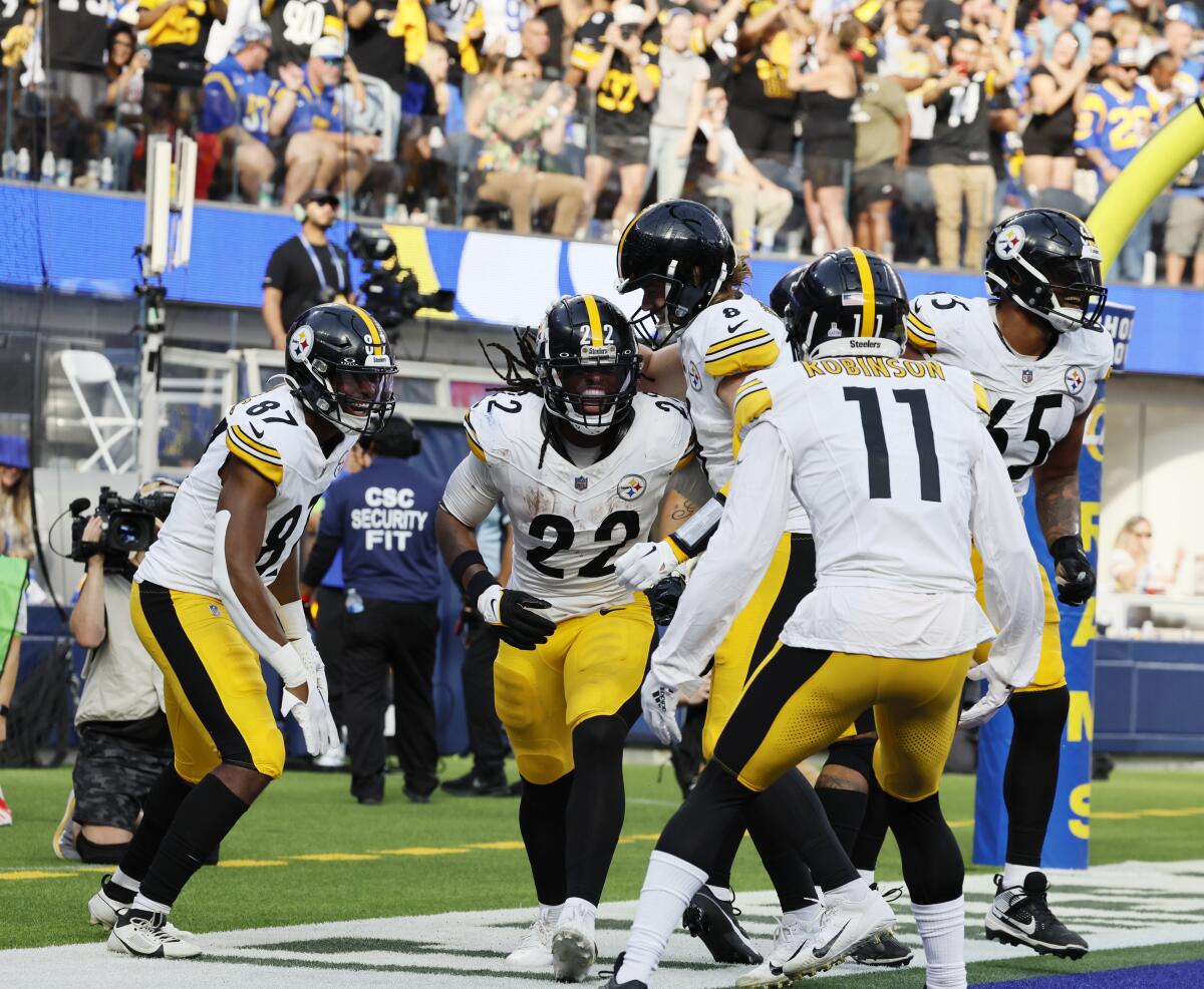 Pittsburgh Steelers running back Najee Harris celebrates with teammates after scoring a touchdown.