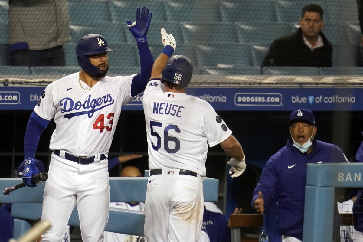 Los Angeles Dodgers' Sheldon Neuse (56) celebrates his solo home run with Edwin Rios (43) during the seventh inning.
