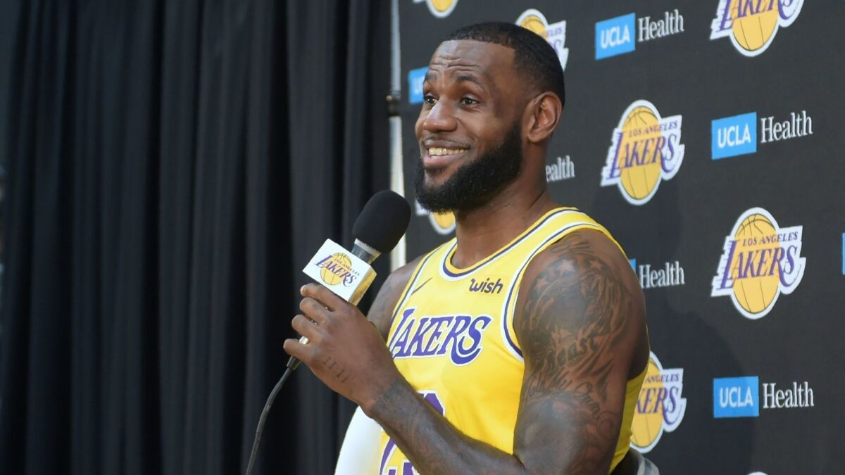 LeBron James responds to questions at his news conference on the Los Angeles Lakers' Media Day on Monday in El Segundo. James and the Lakers will play their first exhibition game Sunday in San Diego.