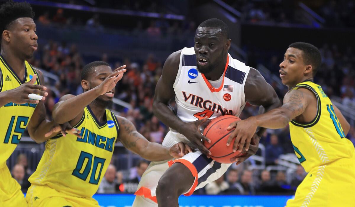 Virginia's Marial Shayok drives to the basket against UNC Wilmington.