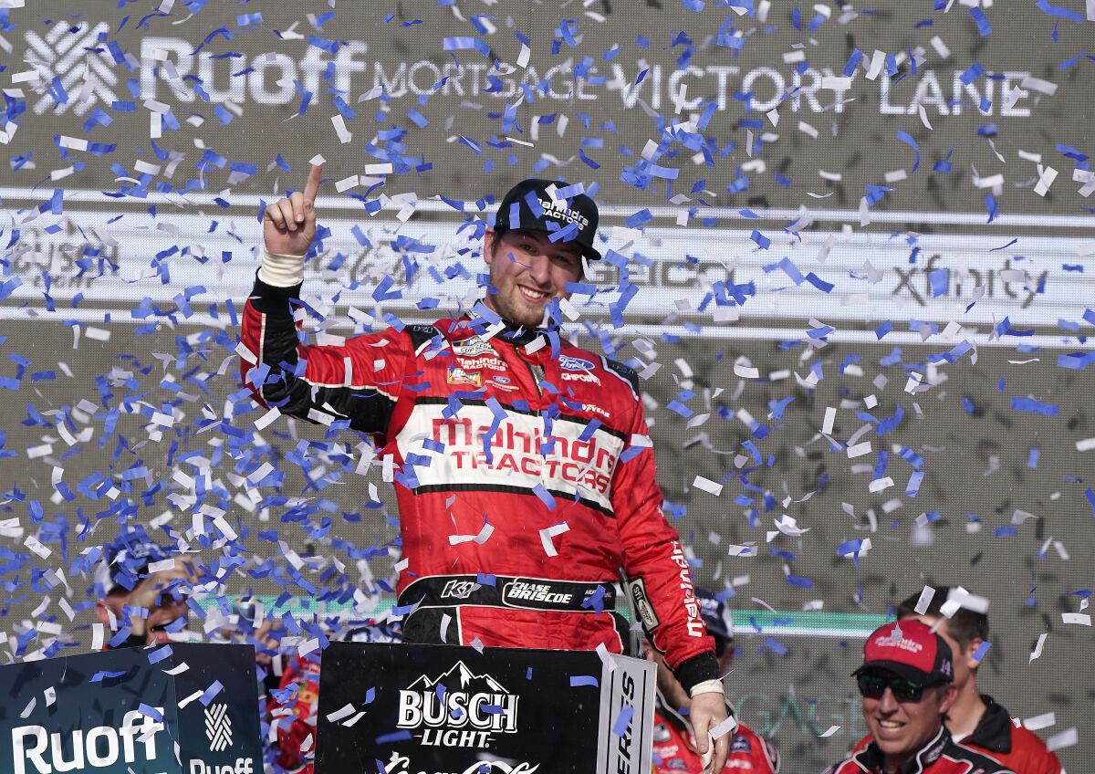 Chase Briscoe, top, celebrates winning a NASCAR Cup Series auto race at Phoenix Raceway, Sunday, March 13, 2022, in Avondale, Ariz. (AP Photo/Darryl Webb)