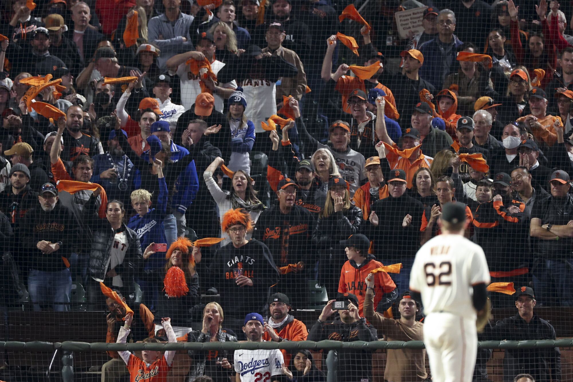 San Francisco Giants fans cheer as starting pitcher Logan Webb prepares to pitch
