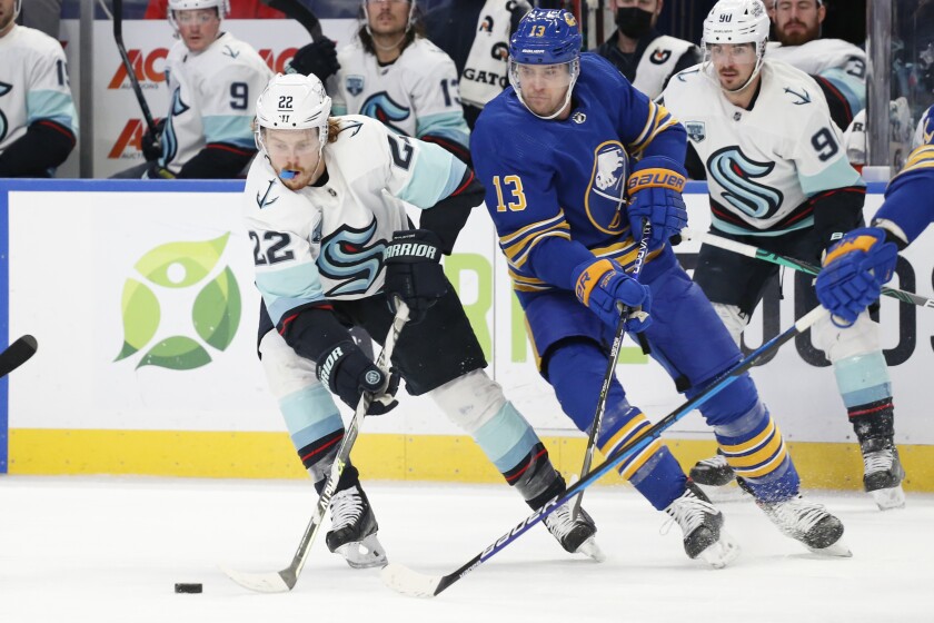 Seattle Kraken center Mason Appleton (22) carries the puck past Buffalo Sabres defenseman Mark Pysyk (13) during the second period of an NHL hockey game, Monday, Nov. 29, 2021, in Buffalo, N.Y. (AP Photo/Jeffrey T. Barnes)